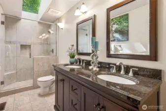 This main floor bath was given the upgrade it deserved. Tile flooring, a spacious tile and glass shower under a skylight, and a double sink vanity with espresso-toned cabinetry all work together to create a crisp, cohesive space. Undermount sinks keep the lines clean, and storage underneath means it’s beautiful and functional. It’s a refresh done right, simple, timeless, and built to last.