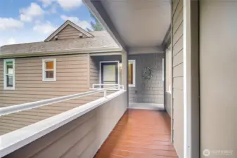 Covered walkway from side garage door to front door. Room for hanging plants and pots.