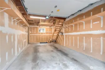 1-car oversized garage with steps up to storage.