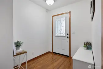Bright entry is a wonderful landing spot to welcome guests and friends, with enclosed mini-blinds inside the beveled glass of the door for light and privacy options.