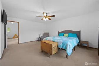The split floor plan has this bedroom off the family room, while the other bedrooms are on the other side of the stairs.