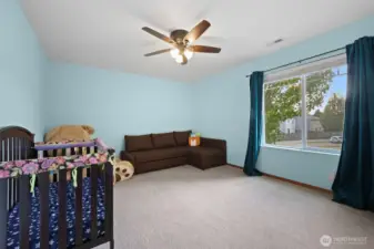 Bedroom #2 offers a front yard view and also has a ceiling fan...