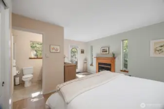 Looking across the primary bedroom with the full bath and the door that leads to the very private deck.