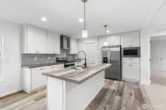 Well-appointed kitchen with a large eat-in island and plenty of cabinets for all your needs.