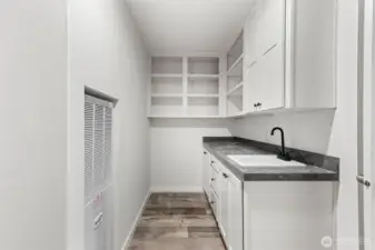 Utility room with more cabinet and storage space.  Can also keep food items in this space to allow for more kitchenware in the kitchen!