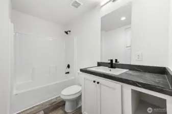 Guest bathroom off the hallway to three bedrooms