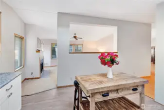 From the kitchen, this photo shows the gas log fireplace in the living room & a glimpse of the family room & dining room on the right.