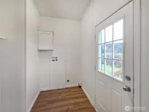 Well-placed laundry room with access to the back porch, providing easy entry for outdoor projects making outdoor projects easy access.