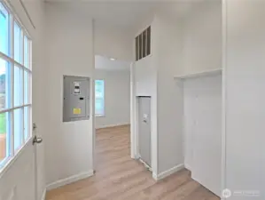 View from the laundry area toward the breakfast nook, where natural light and farm views create a welcoming space.