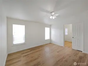 Private primary suite with  fresh flooring and room for your bedroom set.