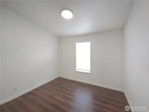 Bedroom 2 located near the hall bath, offering flexible space for visitors, a nursery, or a home office.