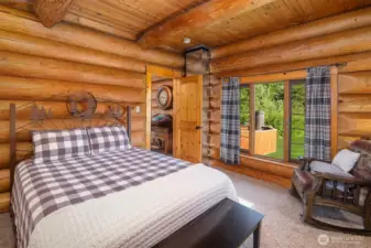 Cozy guest suite featuring classic log interiors, warm wood tones, and tranquil views of the surrounding grounds—perfect for a peaceful mountain retreat.