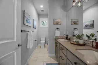 Upper level, full bathroom with dual vanity sinks.