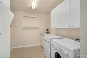 This laundry utility room is huge with tons of storage and space for messy projects.