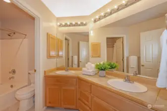 Additional full bathroom featuring a shower-tub combination and neutral finishes, ensuring both style and functionality.