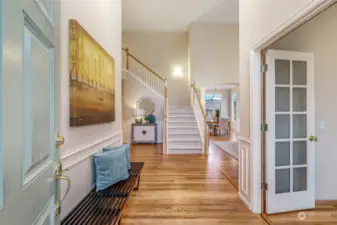 Step inside to a beautifully designed foyer featuring refinished hardwood floors and high ceilings that create an airy, open ambiance. The elegant staircase adds architectural interest, while natural light floods the space, making a lasting first impression.