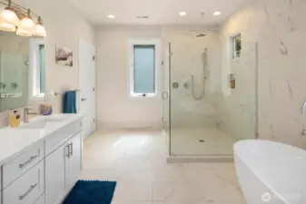 Enter the luxurious primary bath, with heated floors, oversized shower, and deep soaking tub.