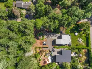 Aerial perspective shows this shy-acre corner lot in all its verdant glory!