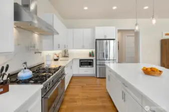 Stainless steel appliances, including 6-burner Bertazzoni range and double oven.