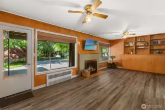 Lovely family room with built-in-bookcase and fireplace overlooks the covered backyard patio. Or, use this space as an office, library, playroom, craft room, etc.  The possibilities are endless.
