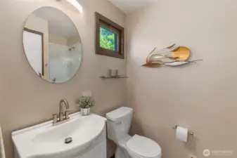 Primary bedroom features a  3/4 bath and good-sized  linen closet behind the door. Note the shower in the mirror.