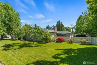 Beautiful grounds offer mature landscaping, and fenced backyard on this shy 1/3 acre corner lot.