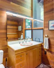 Second bathroom offers shower and vaulted ceiling.