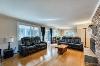 Living room looking towards small dining room. Sliding door to the back and French doors to the side yard