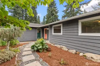 Stepping-stone path and low-maintenance landscaping leading to the door.