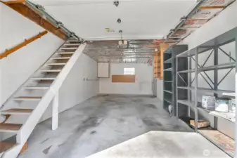 Great garage with storage and overhead storage accessed by walkup staircase.