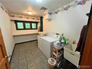Large laundry room with laundry shoot.