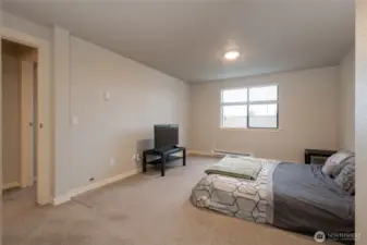 Spacious primary suite with attached half bath and two large closets