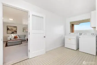 HUGE upper unit laundry room with storage area.