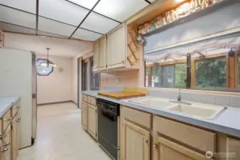 Looking toward the dining room from the kitchen. There is a lovely stained glass window at the dining room.