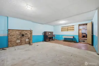 Looking across the family room toward the area that had a wood stove. The floor is brick toward the rear entry area.