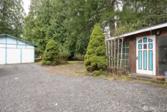 Looking at the back or rear entry and the shop building on the property.