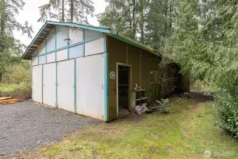 The shop has large doors that open as well as a side door.