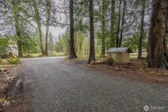 The home is setback off the Custer School Road with the well pumphouse along the driveway.