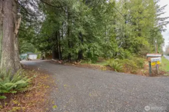 Looking from the road toward the home with the shop beyond.