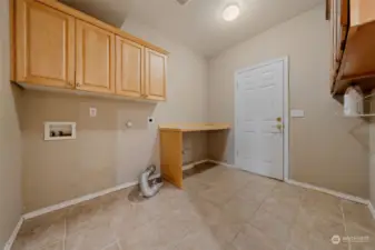 Huge laundry room with cabinets and counter so convenient for folding laundry.