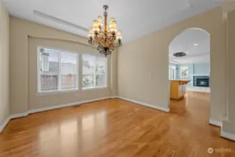 Formal dining room with coffered ceilings and large window providing an abundance of natural light.