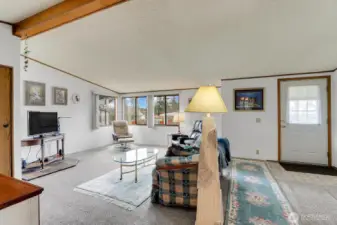 Living Room with Vaulted Ceiling & Corner Windows for an abundance of natural light!