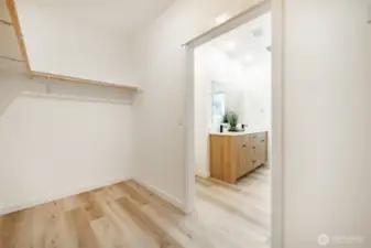 Spacious primary closet. Photos shown are of a similar floor plan previously built in a different neighborhood (The Ridge in Blaine). Finishes and features may vary. Some items pictured reflect buyer-selected upgrades which are not included in the base price and may be added at an additional cost.