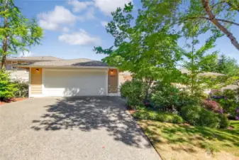 Lovely inviting front of condo - shows like a home. 2-car garage with driveway parking & extra office/tool/storage room.