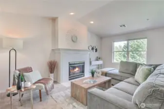 Living Room with vaulted ceilings, gas fireplace and breathtaking views to natural green area.