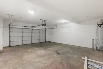 A two car garage with a condo?  Yes indeed.  It's all sheet rocked and finished too.  Walk right from your car directly into the entry room!  "Honey, I'm home."