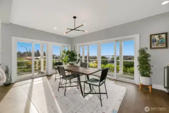 Formal dining room surrounded by light, windows, and views.