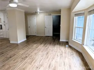 Open floor plan living area with brand new gas fireplace & LVP flooring. #11823 150th St Ct E, Puyallup, WA 98374