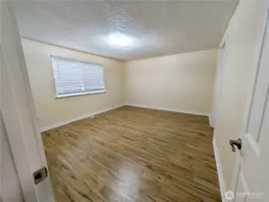 Primary bedroom with new LVP flooring. #11823 150th St Ct E, Puyallup, WA 98374