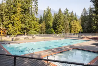 Community outdoor pool and hot tub with fenced deck area.
